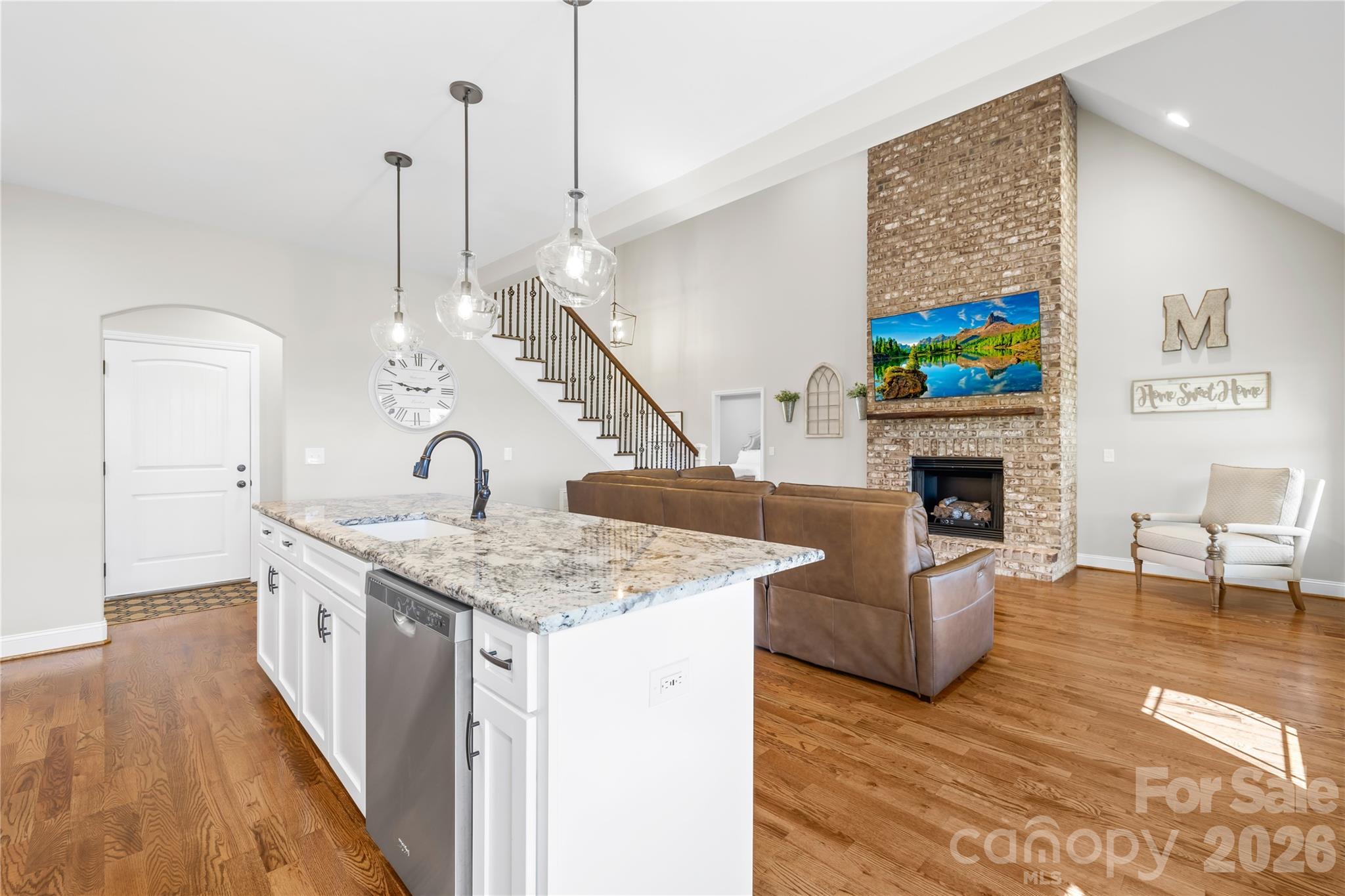895 Oak Ridge Farms Circle Newton, NC 28658 - Photo 23 of 43 a kitchen with a sink a stove and chairs with wooden floor