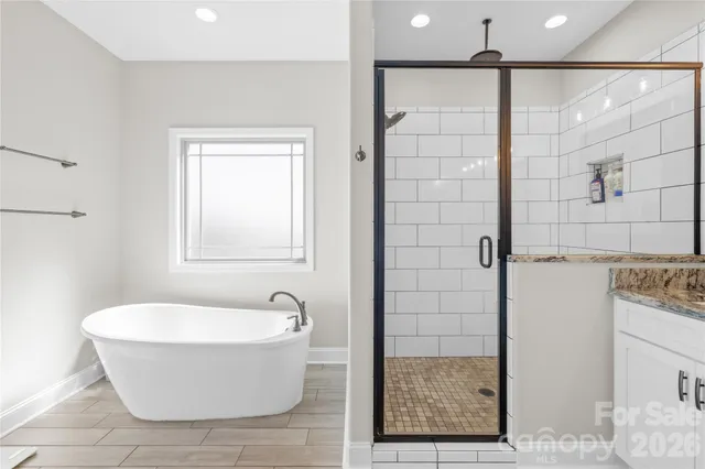 a bathroom with a bathtub and shower