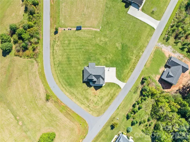 a view of a pathway with a big yard