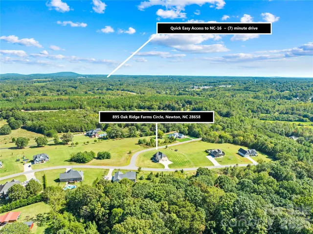 a view of a swimming pool with a patio and a yard