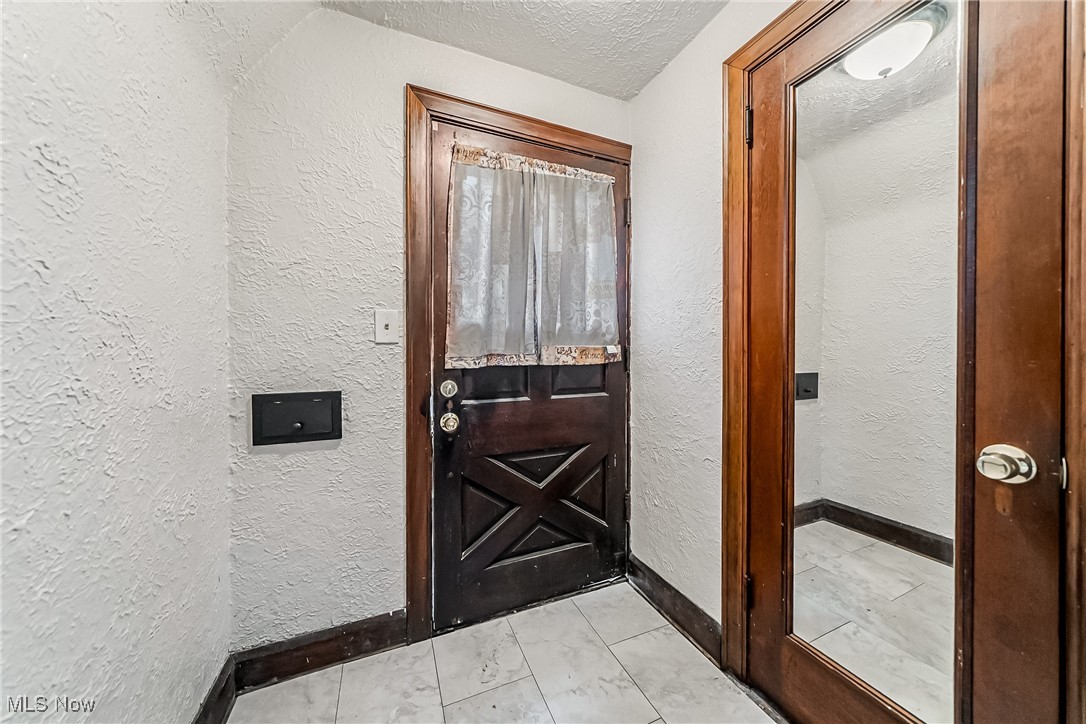 1271 Winston Road Cleveland, OH 44121 - Photo 5 of 43 Entryway featuring a textured wall and a textured ceiling