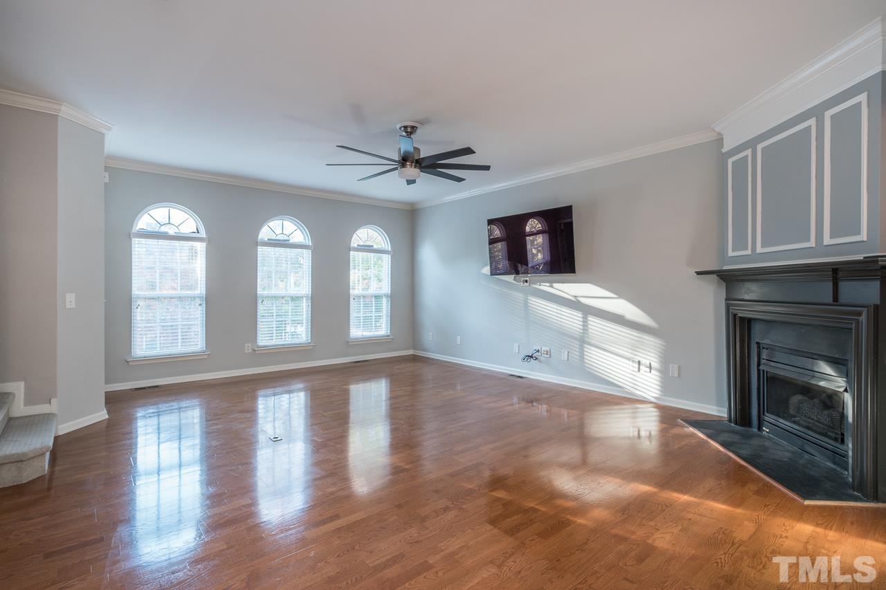 7244 Janston Drive Raleigh, NC 27613 - Photo 2 of 19 a view of an empty room with a fireplace and a window
