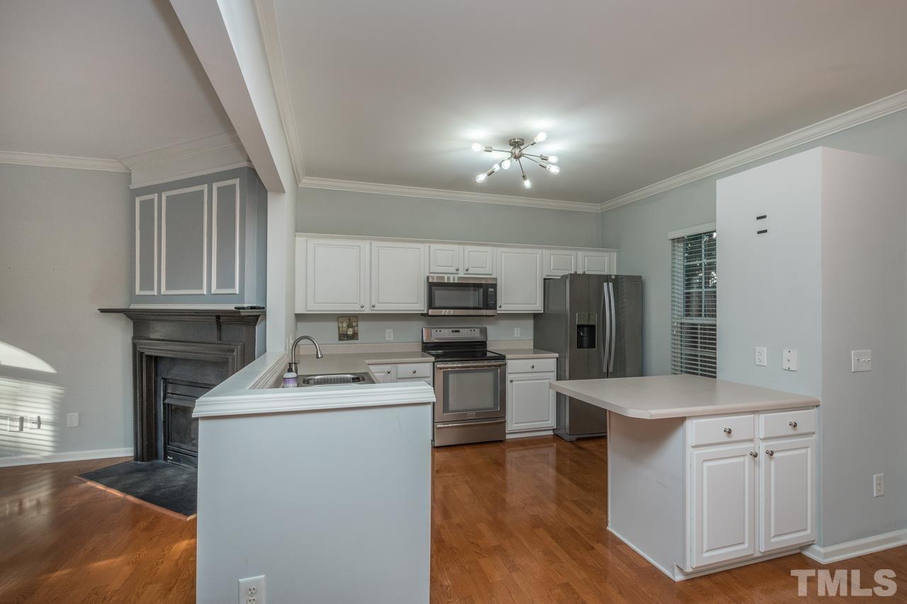 7244 Janston Drive Raleigh, NC 27613 - Photo 4 of 19 a kitchen with a sink stove and refrigerator