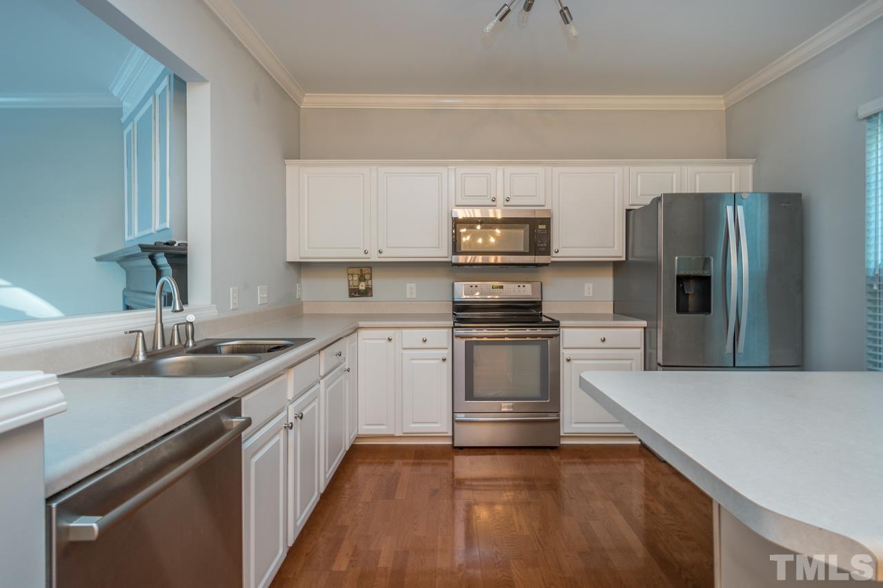 7244 Janston Drive Raleigh, NC 27613 - Photo 5 of 19 a kitchen with stainless steel appliances a sink stove and refrigerator