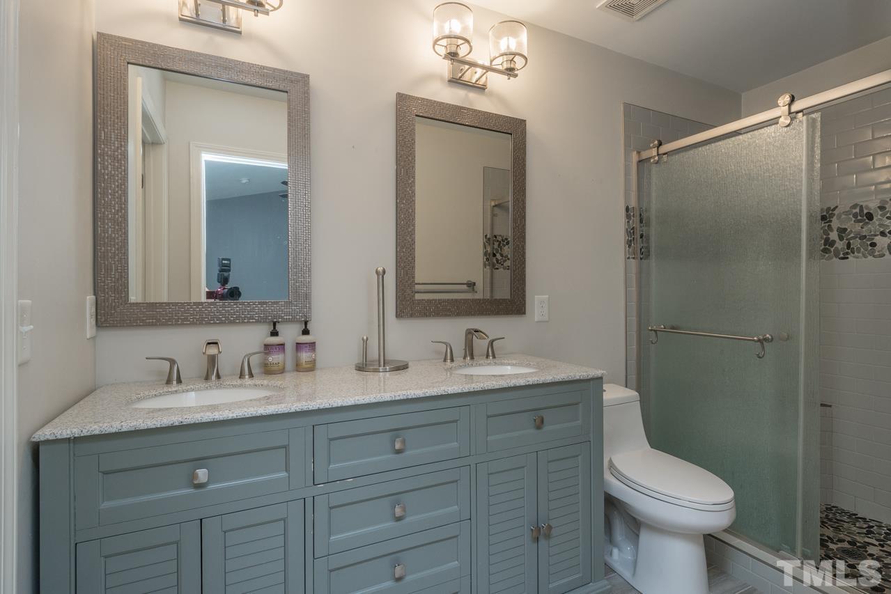 7244 Janston Drive Raleigh, NC 27613 - Photo 9 of 19 a bathroom with a toilet sink and mirror