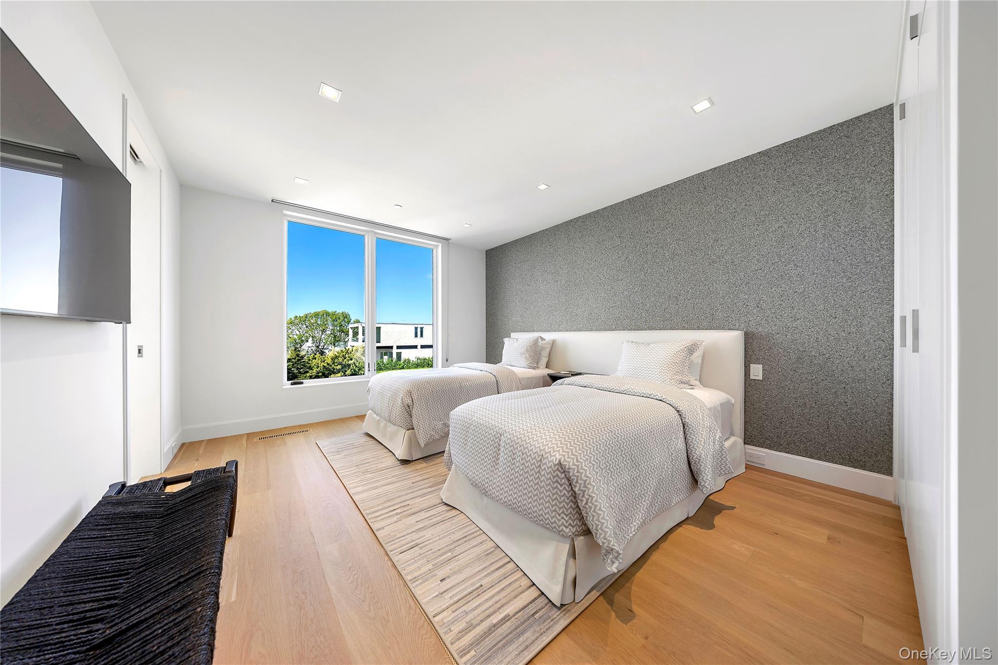 345 Dune Road Westhampton Beach, NY 11978 - Photo 21 of 34 a bedroom with a bed and a window