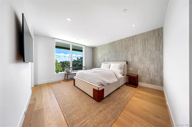 a spacious bathroom with a double vanity sink toilet mirror and bathtub