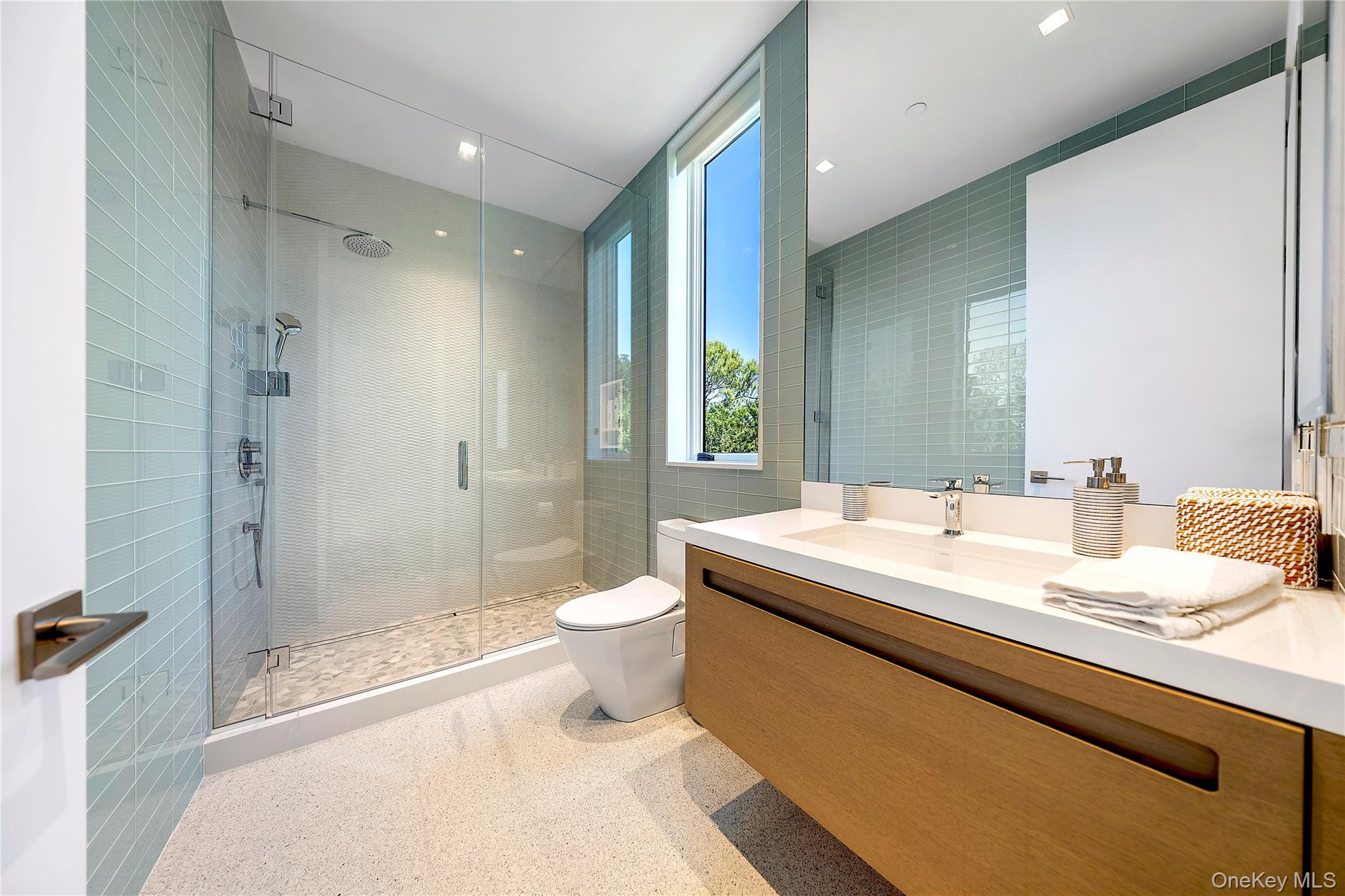 345 Dune Road Westhampton Beach, NY 11978 - Photo 27 of 34 a bathroom with a sink a toilet and shower