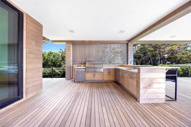 a view of a kitchen with a sink and dishwasher with wooden floor