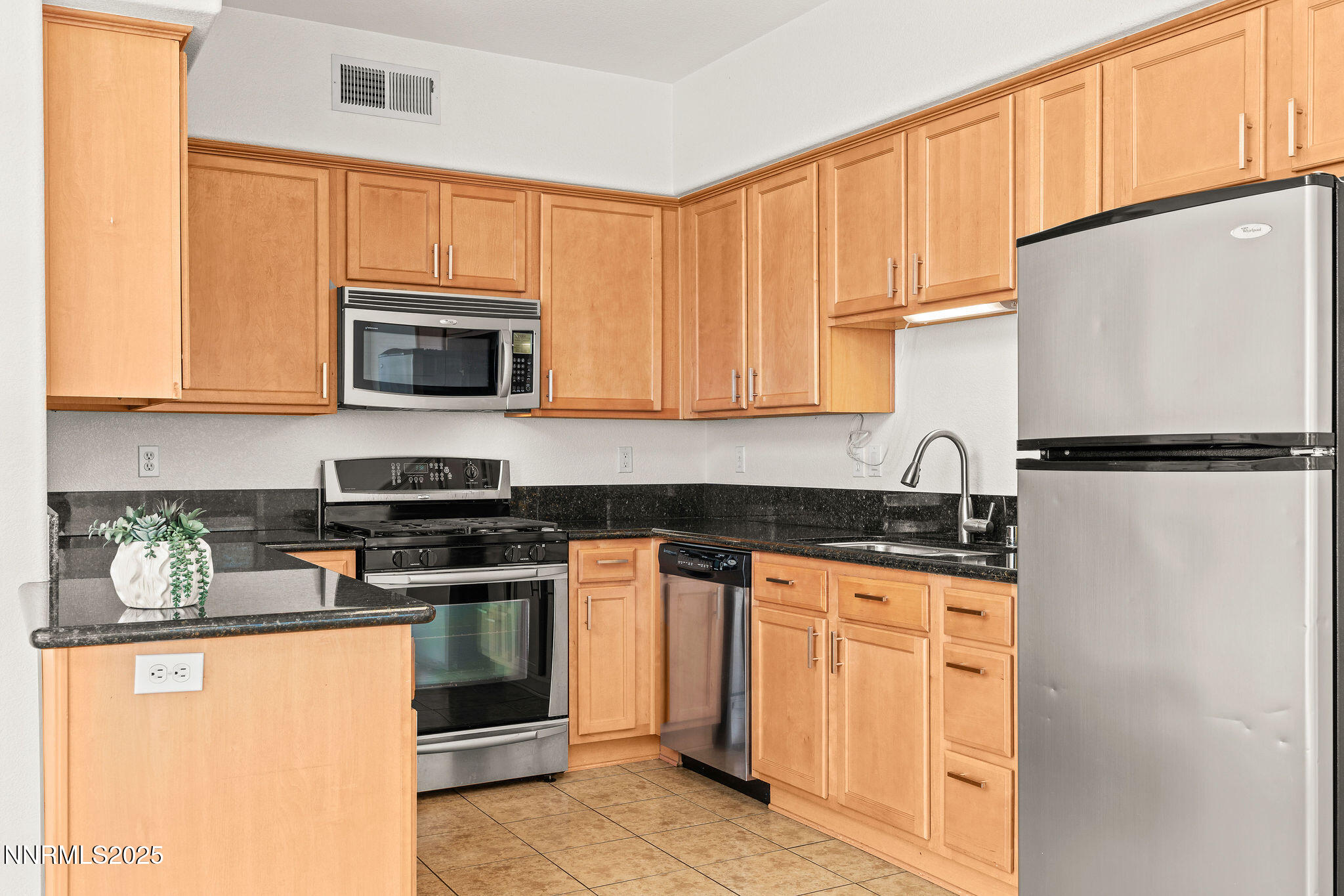 2125 Stanton Lane Reno, NV 89502 - Photo 14 of 48 a kitchen with granite countertop a refrigerator stove top oven a sink and dishwasher