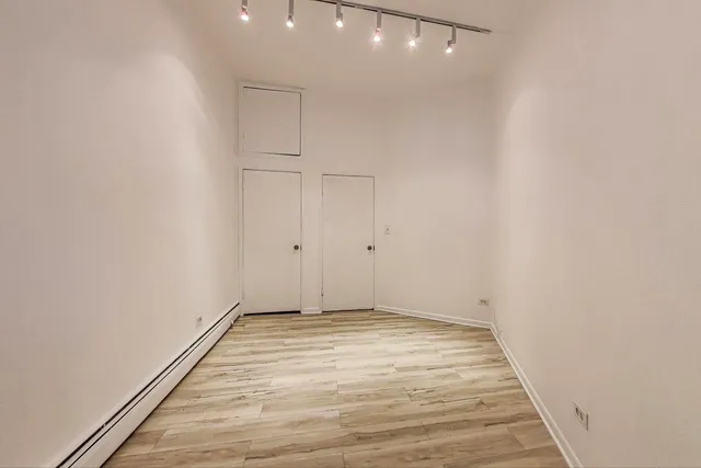 a view of room with wooden floor