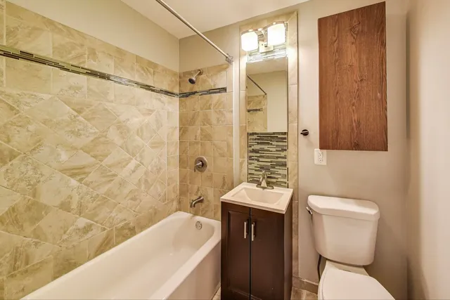 a bathroom with a toilet a sink and bathtub