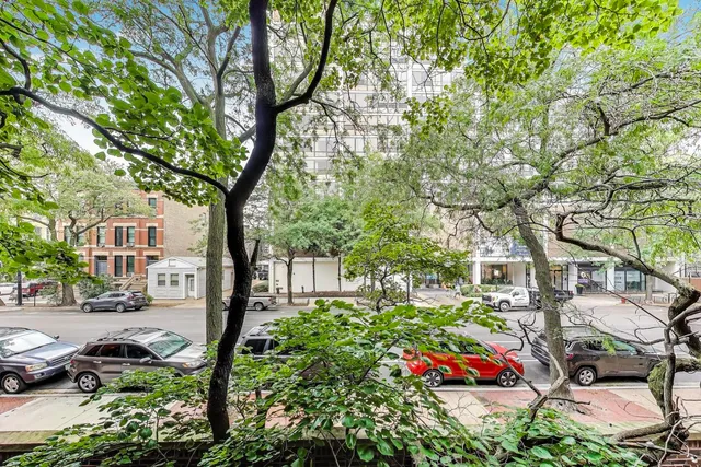 a street view with couple of cars parked on road