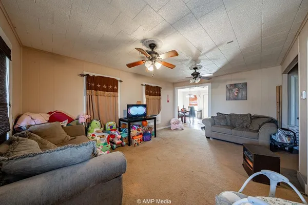 a bedroom with a bed and a flat tv screen on dresser