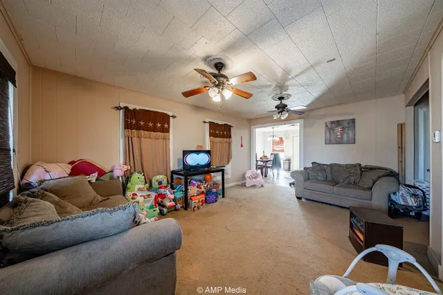 a bedroom with a bed and a flat tv screen on dresser