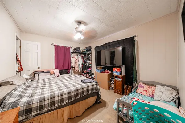 a bedroom with bed and a chandelier