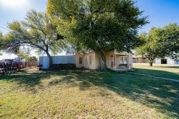 a view of a yard with a house and a tree