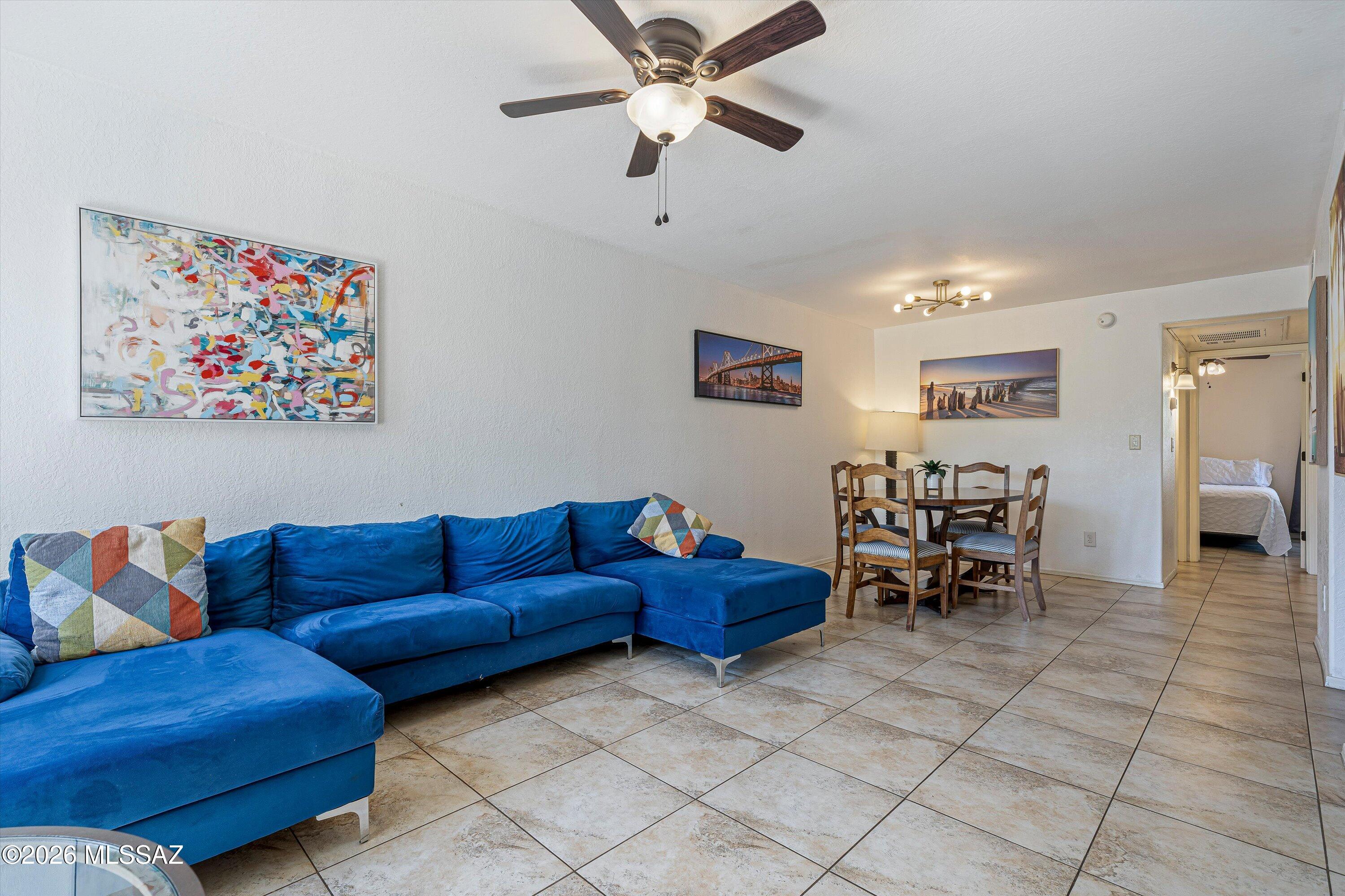 5800 North Kolb Road, Unit 5125 Tucson, AZ 85750 - Photo 4 of 34 a living room with furniture and a dining table