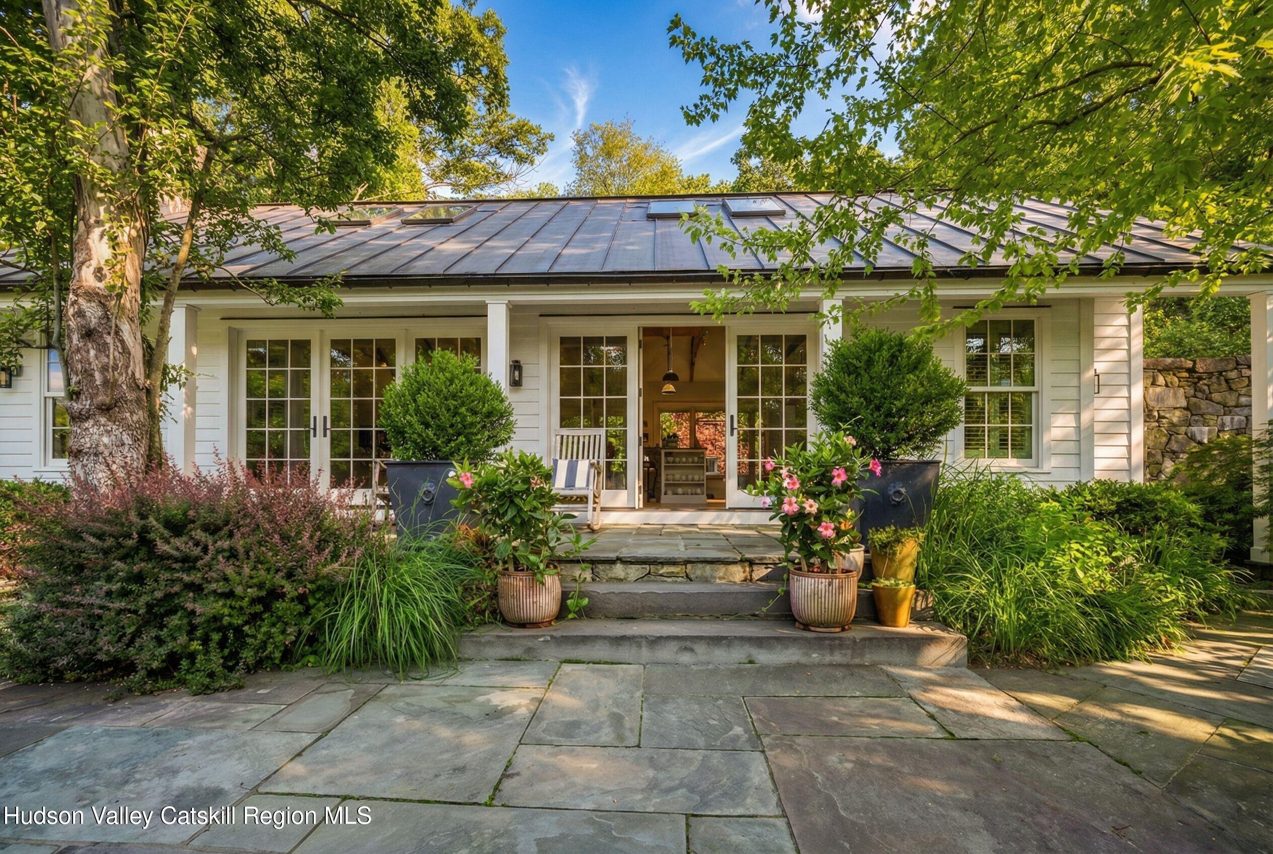 47 White Bridge Road Old Chatham, NY 12136 - Photo 33 of 68 front view of a house with a large window and potted plants