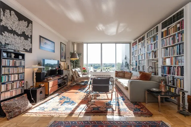 a living room with furniture and a book shelf