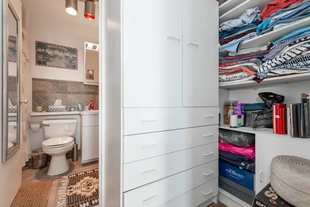 a bathroom with a toilet and a shower