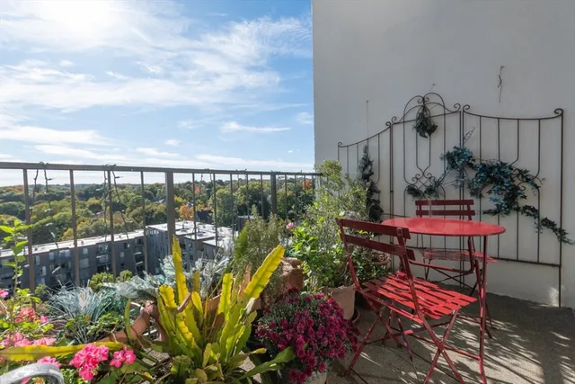 a view of a chairs and table in the balcony