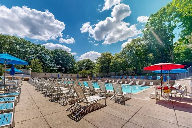 a view of a patio with a table and chairs under an umbrella