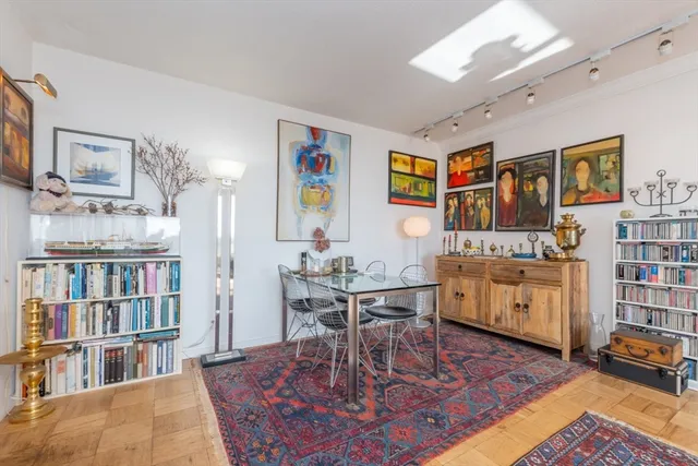 a living room with furniture and a book shelf