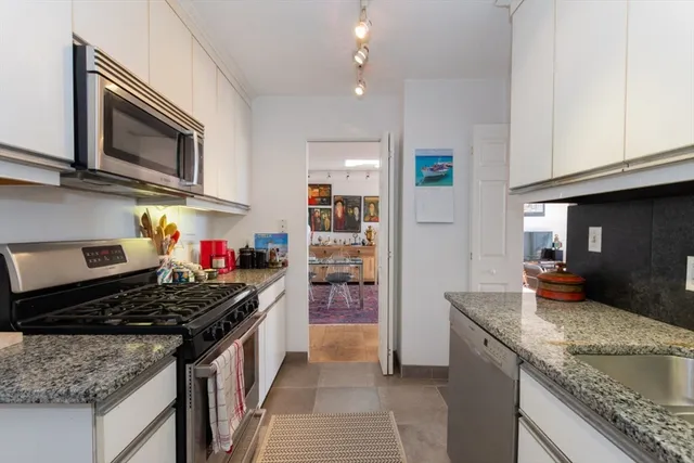 a kitchen with stainless steel appliances granite countertop a stove and a sink