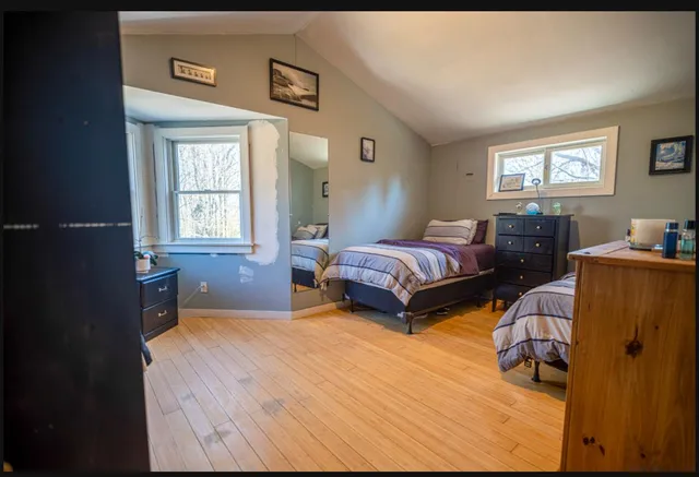 a bedroom with two beds and a window