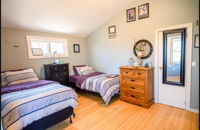 a bedroom with two beds and a closet