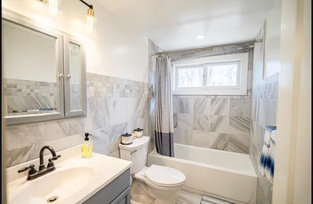 a bathroom with a sink toilet and shower