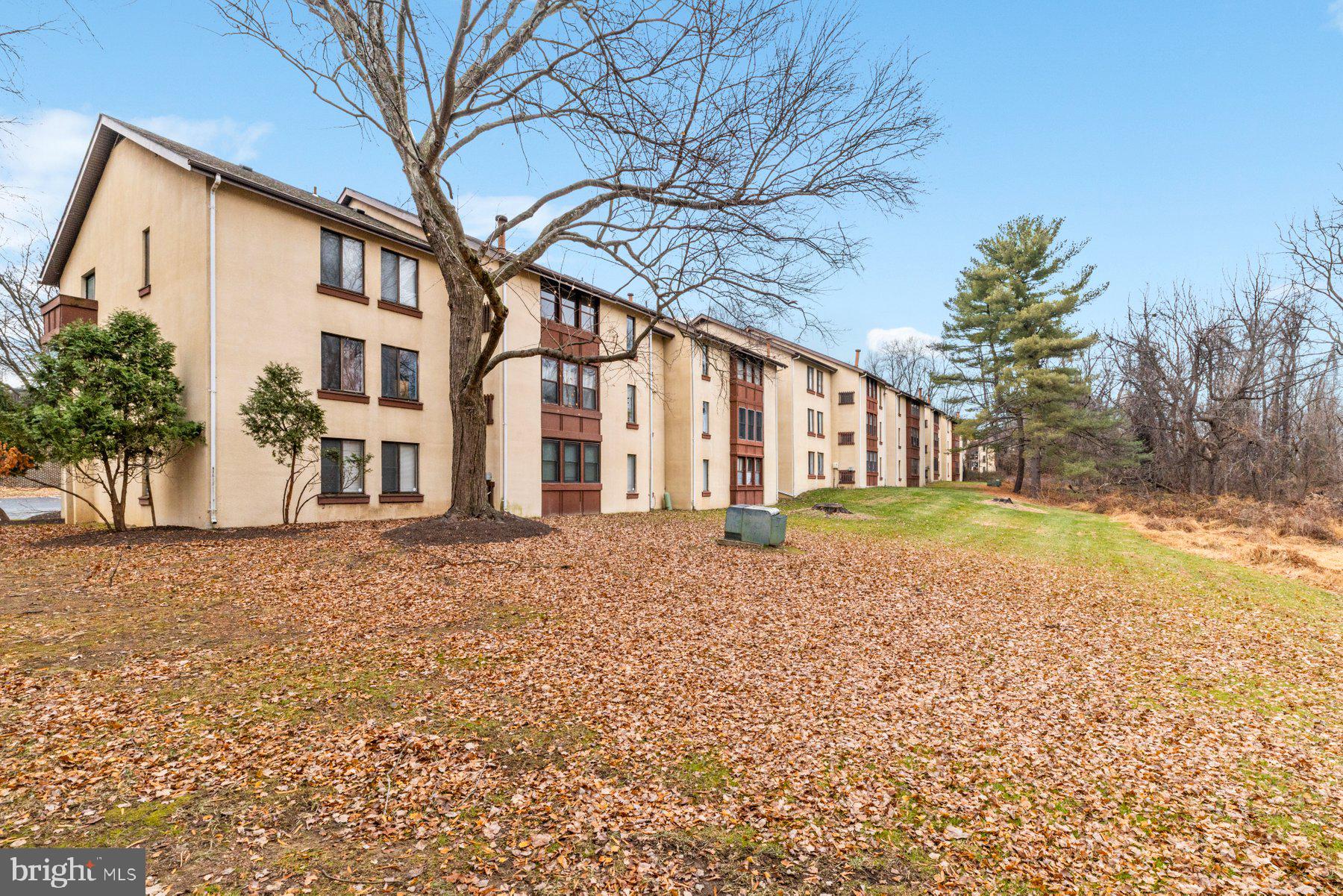 5866 Thunder Hill Road, Unit A4 Columbia, MD 21045 - Photo 19 of 20 a view of a house with a yard and garage