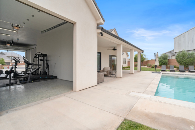 2278 Tawny Ridge Circle St. George, UT 84790 - Photo 60 of 61 Outdoor living space featuring a covered patio, inground swimming pool, and concrete decking.