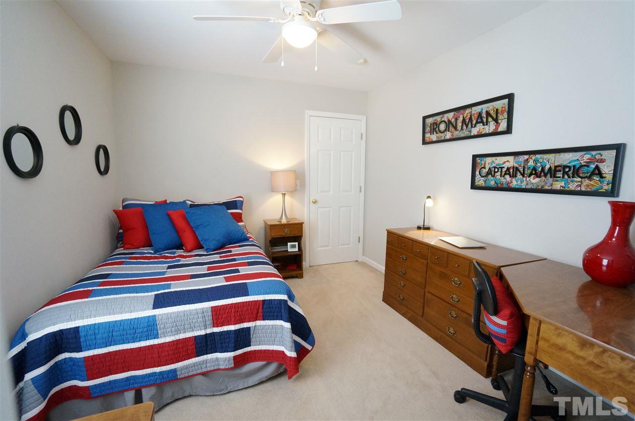2401 Springfield Park Drive Raleigh, NC 27614 - Photo 14 of 25 a bedroom with a bed and a chandelier