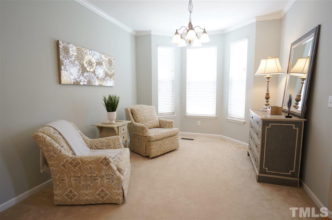 2401 Springfield Park Drive Raleigh, NC 27614 - Photo 3 of 25 a living room with furniture and a chandelier