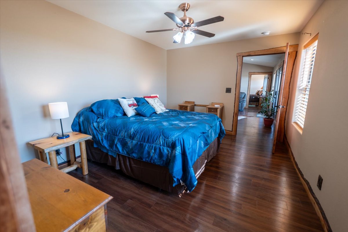 1825 Savanna Ridge Ranch Road Lometa, TX 76853 - Photo 19 of 35 Bedroom with dark wood finished floors and ceiling fan