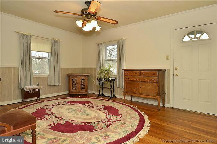 4219 Round Hill Road Silver Spring, MD 20906 - Photo 14 of 19 a bedroom with a bed and a chandelier
