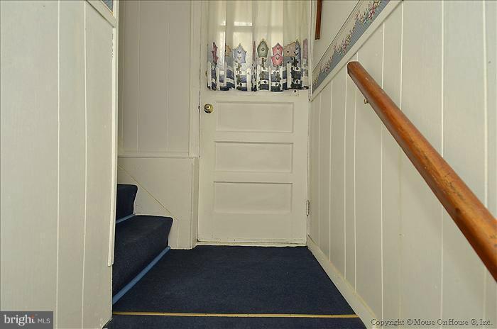 4219 Round Hill Road Silver Spring, MD 20906 - Photo 3 of 19 a view of a hallway with wooden floor and staircase
