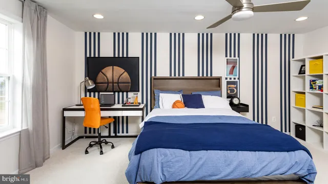 a living room with a bed furniture and a window