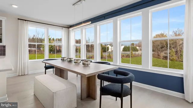 a view of a kitchen area with furniture and large windows