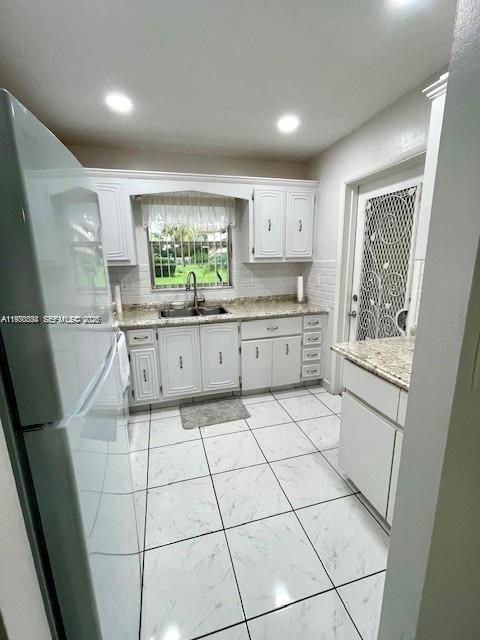 5300 Washington Street, Unit S112 Hollywood, FL 33021 - Photo 5 of 10 a kitchen with stainless steel appliances a sink and a cabinets