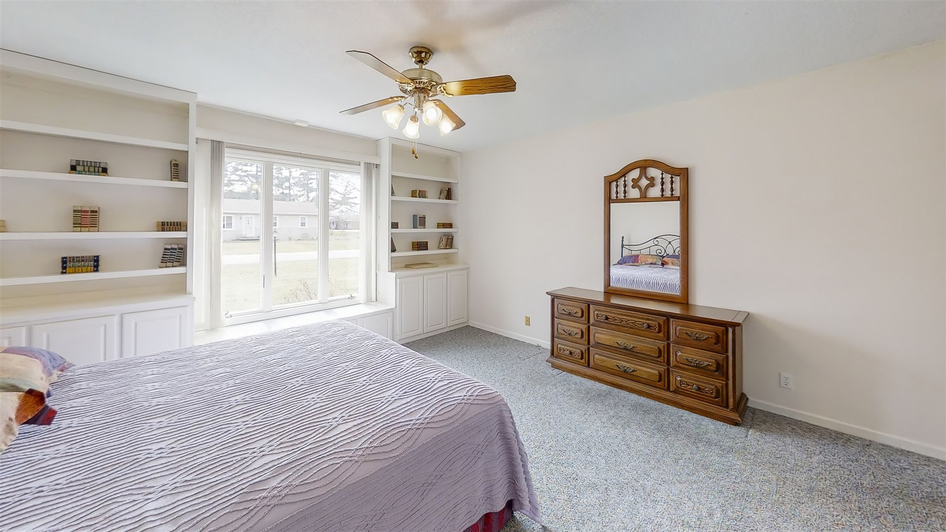 4804 East Powers Boulevard Decatur, IL 62521 - Photo 22 of 45 a spacious bedroom with a bed a dresser and next to a window