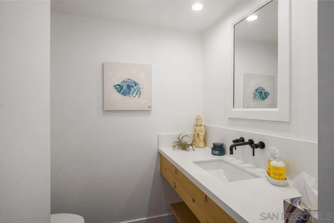 13053 Caminito Del Rocio Del Mar, CA 92014 - Photo 18 of 49 a bathroom with a granite countertop sink and a mirror