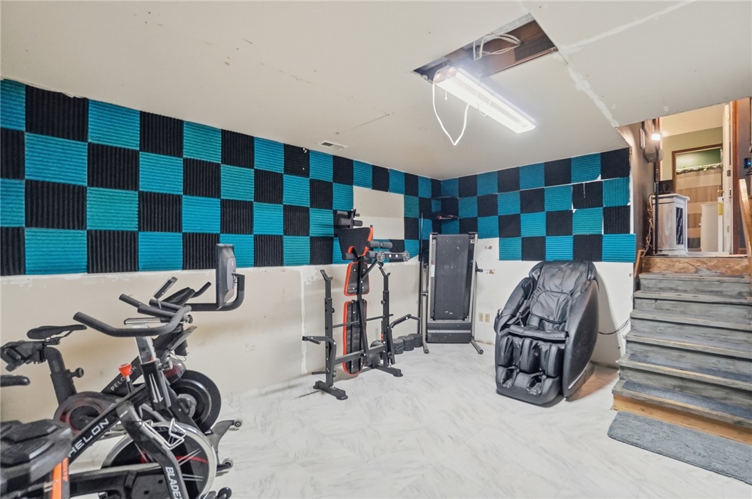5209 North Addison New Carlisle Road St. Paris, OH 43072 - Photo 38 of 47 This dedicated exercise room offers ample space for various fitness equipment, fostering an active lifestyle.