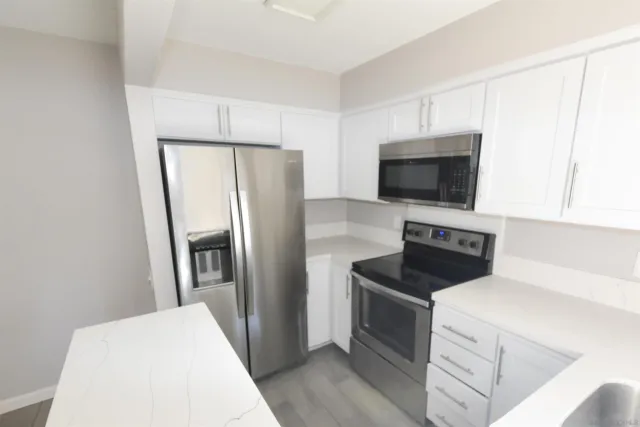 a kitchen with a refrigerator stove and microwave