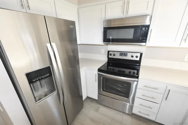 a kitchen with a stove microwave and refrigerator
