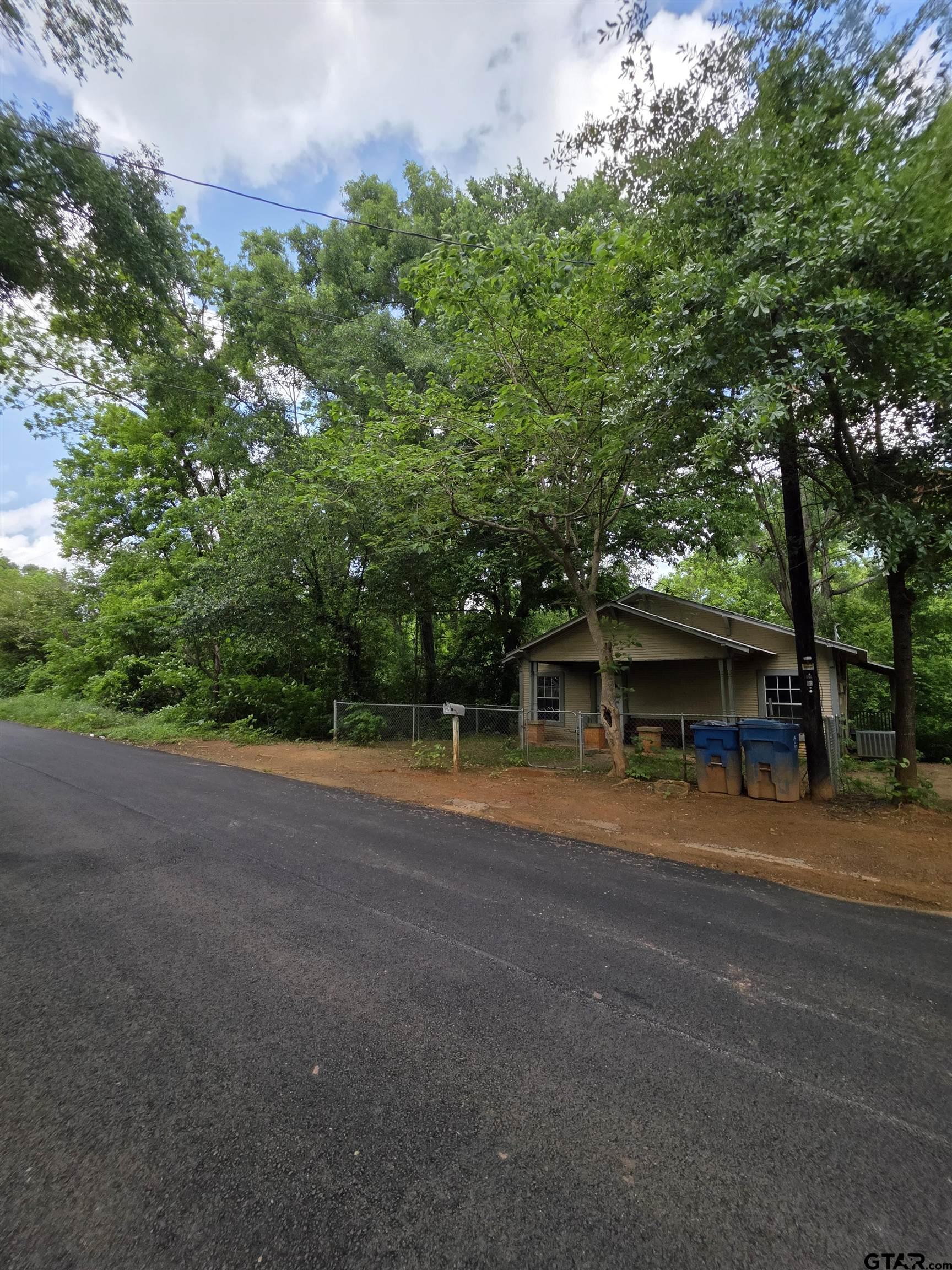 316 North Hospital Street Rusk, TX 75785 - Photo 3 of 21 a view of a house with a yard and garage