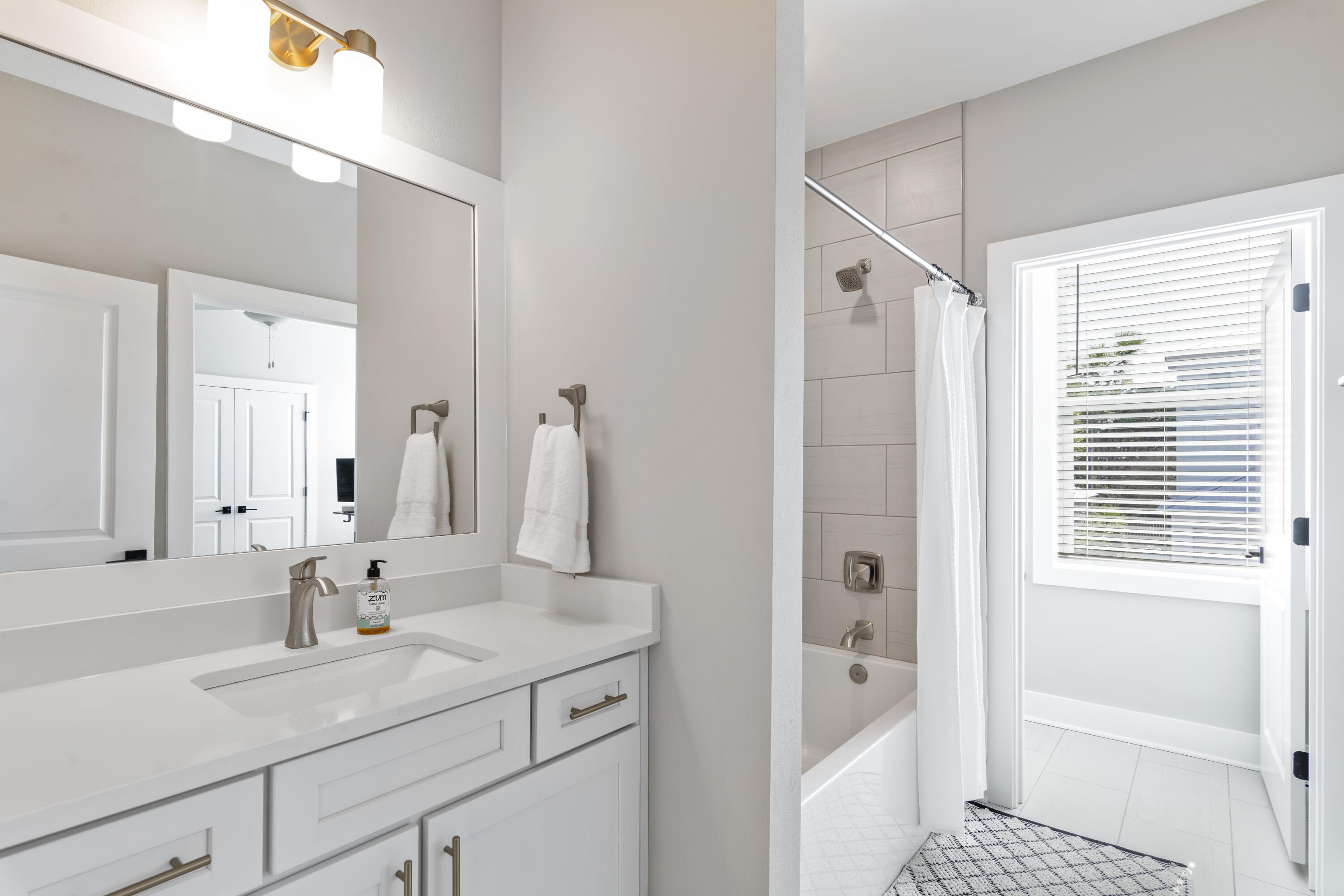 95 West Willow Mist Road Inlet Beach, FL 32461 - Photo 28 of 49 a bathroom with a tub sink and mirror