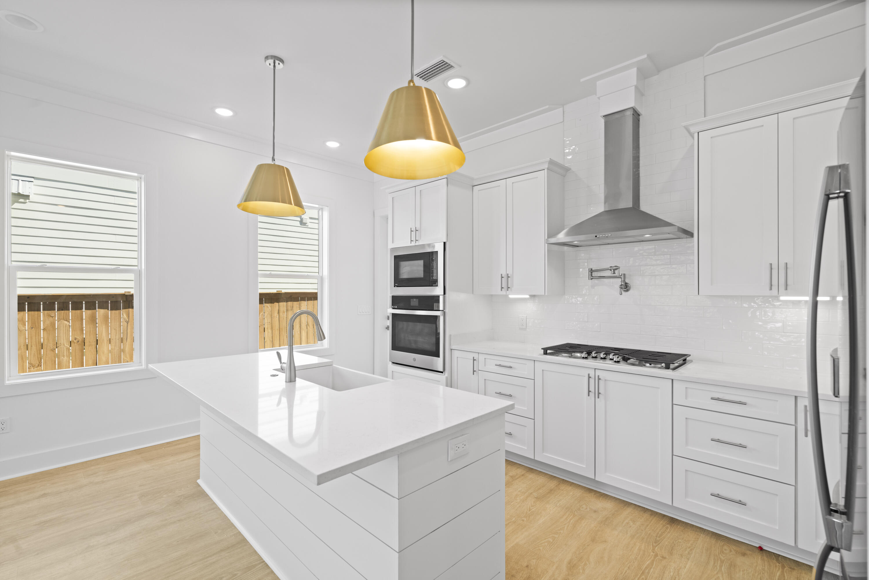 95 West Willow Mist Road Inlet Beach, FL 32461 - Photo 4 of 49 a kitchen with stainless steel appliances granite countertop a sink a stove and a wooden floors